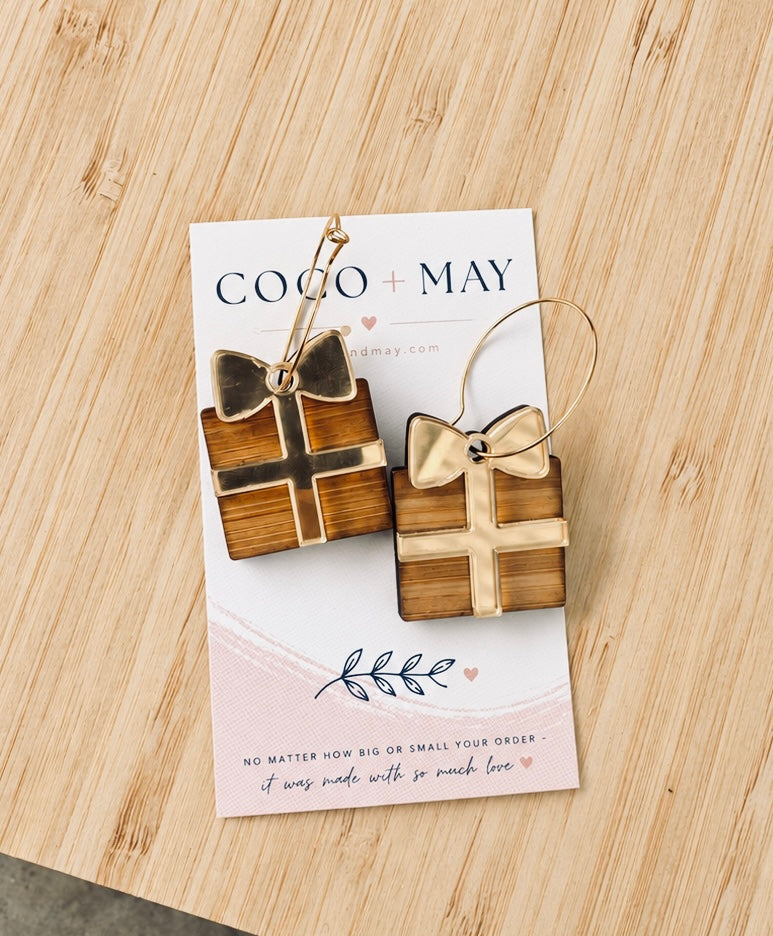 Bamboo and mirror gold acrylic Christmas present dangle earrings with layered gift box and bow design, displayed on a Coco & May jewellery card