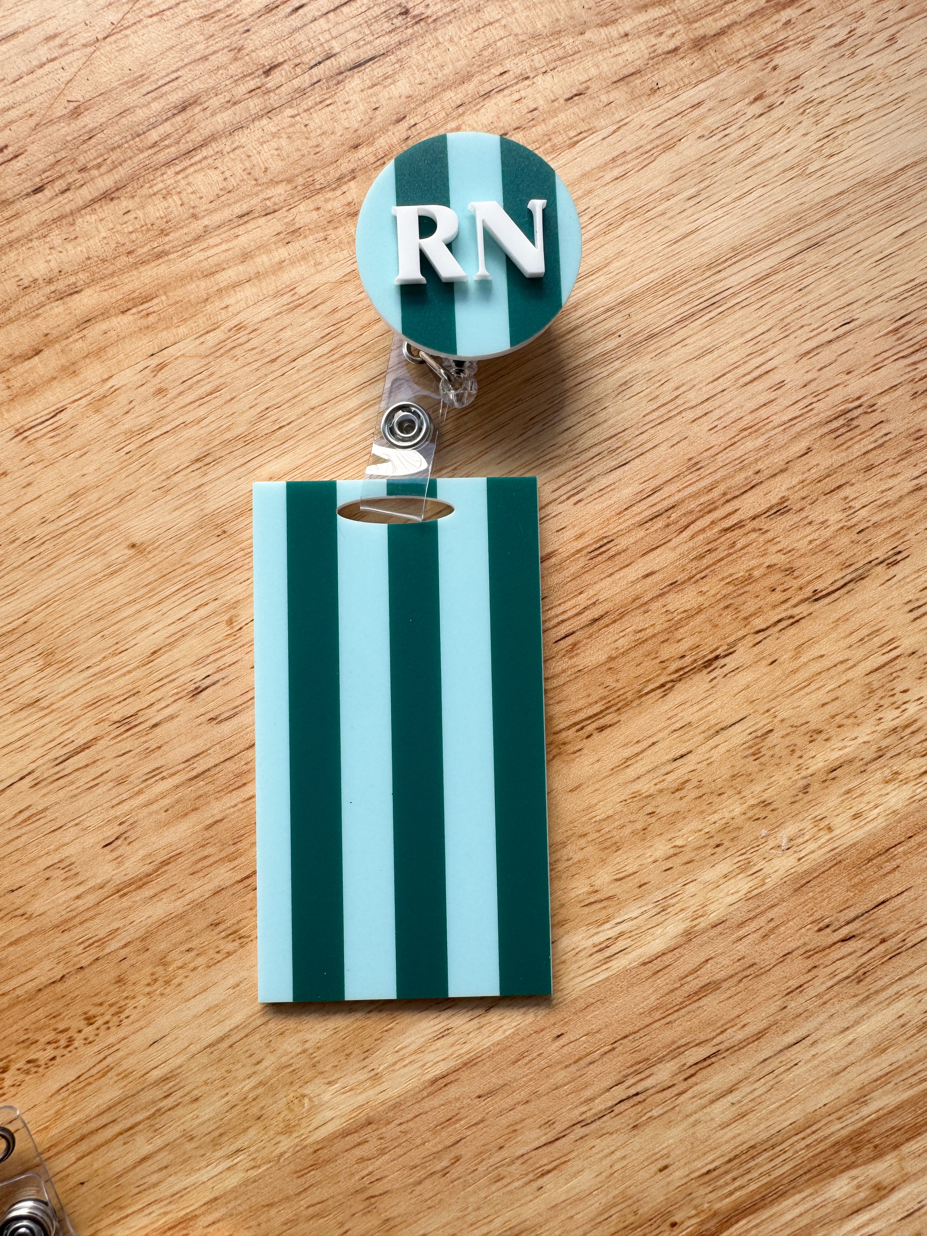 Patterned acrylic badge reel with retractable ID holder, designed for nurses, teachers and everyday workwear.