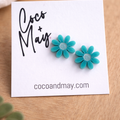Ember teal daisy stud earrings by Coco and May on display card, lightweight floral earrings Australia
