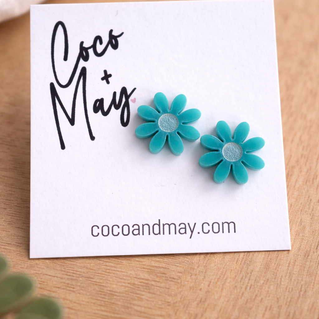 Ember teal daisy stud earrings by Coco and May on display card, lightweight floral earrings Australia
