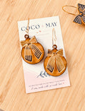 Caramel and black striped bow earrings with gold-tone hoop fittings, displayed on a Coco & May jewellery card