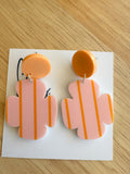 Indie abstract orange dangle earrings by Coco and May on display card, lightweight statement acrylic earrings Australia
