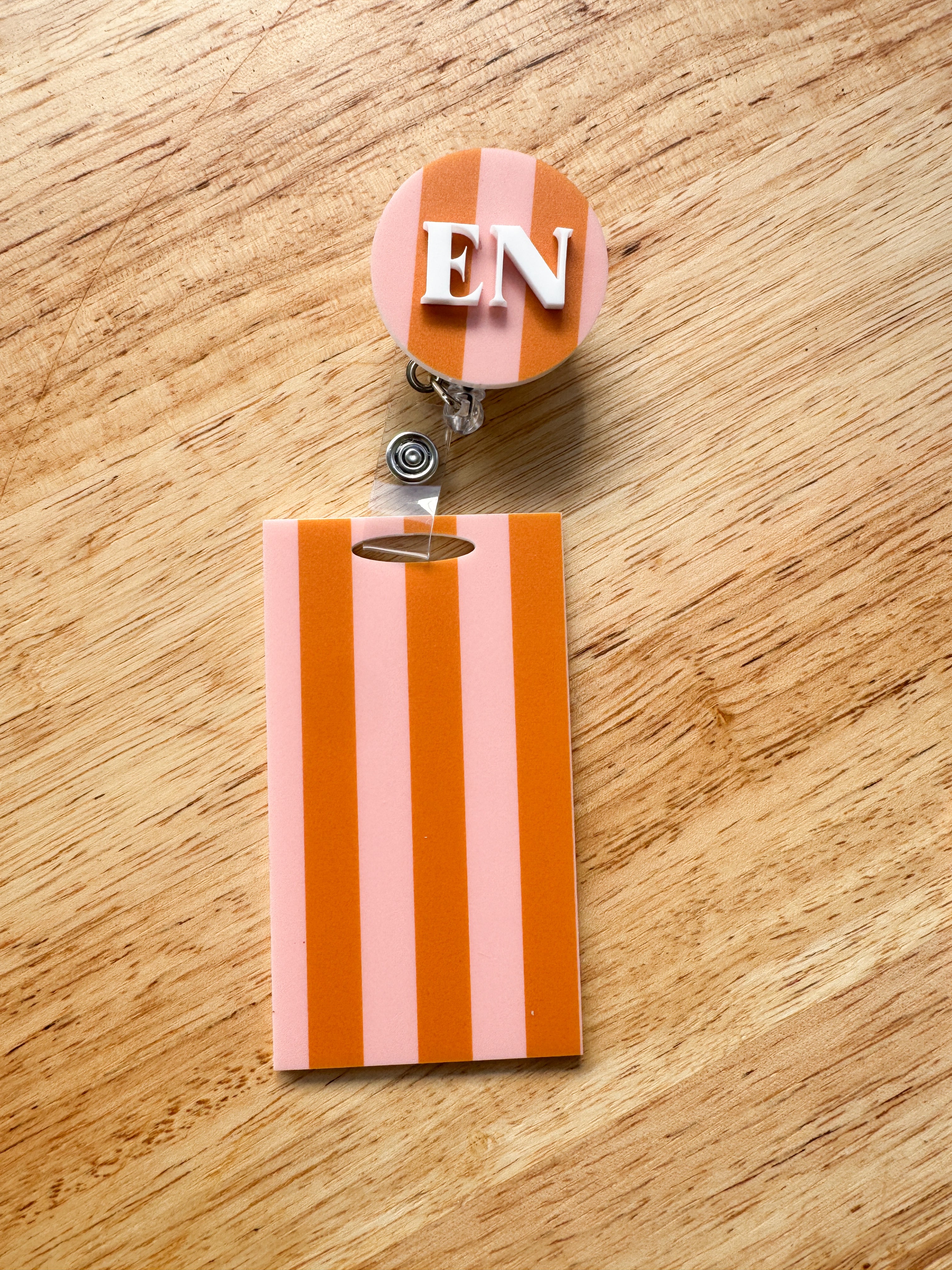 Patterned acrylic badge reel with retractable ID holder, designed for nurses, teachers and everyday workwear.