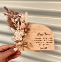 Personalised natural wooden teacher plaque with engraved appreciation message and arrangement of dried flowers in soft neutral tones, by Coco & May