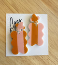 Freya orange statement dangle earrings by Coco and May on display card, lightweight acrylic earrings Australia
