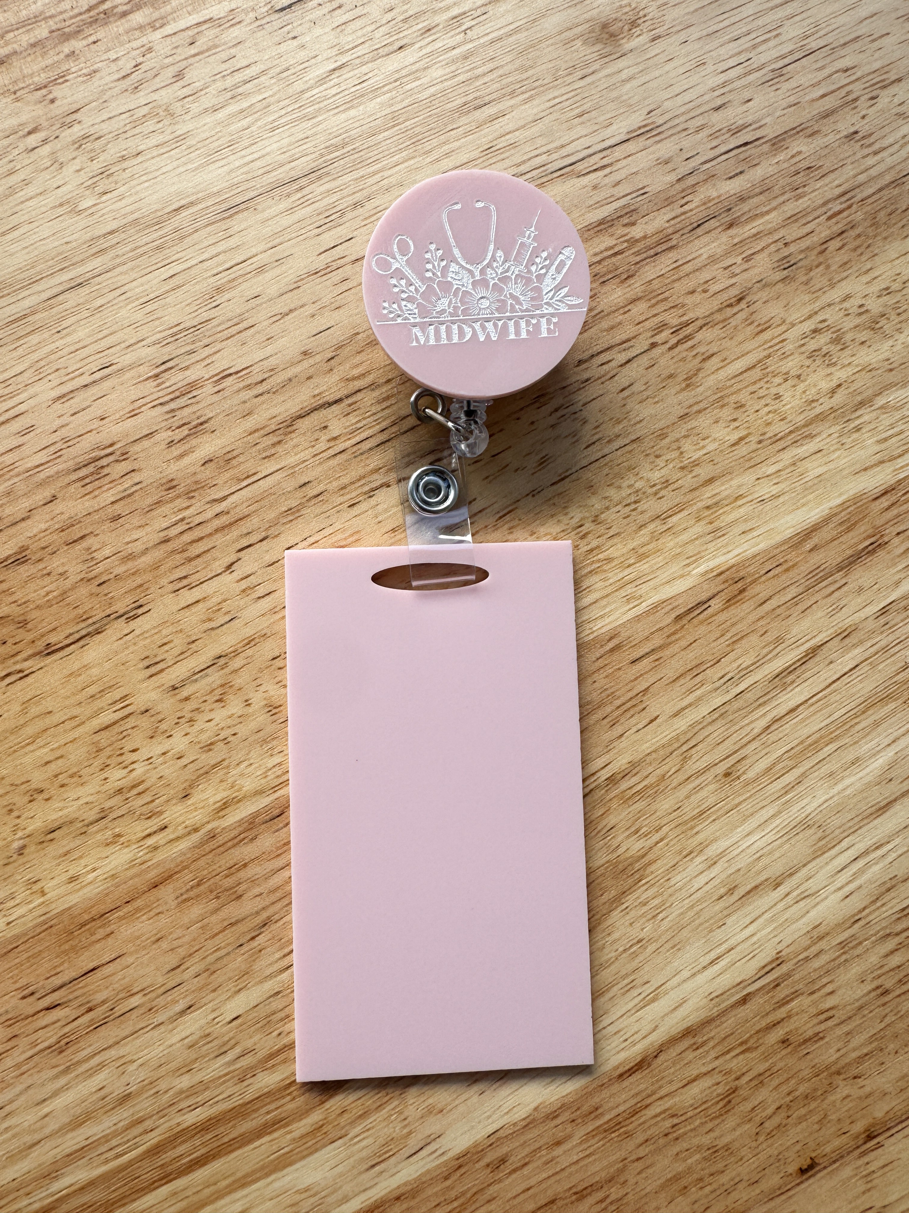 Patterned acrylic badge reel with retractable ID holder, designed for nurses, teachers and everyday workwear.