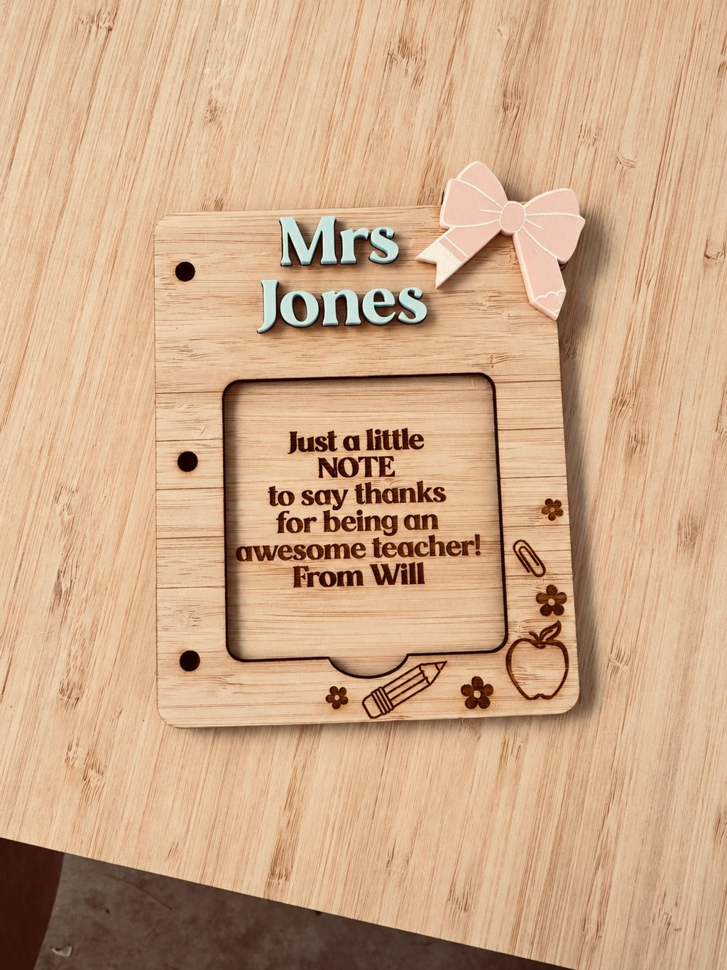 Personalised wooden teacher sticky note holder engraved with Mrs Jones, featuring decorative school-themed details and a teacher appreciation message