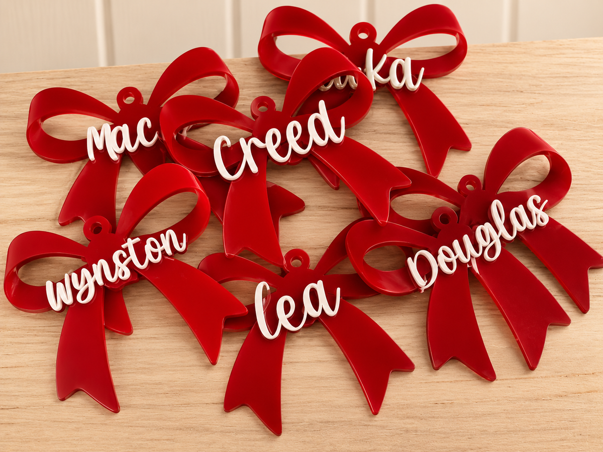 Coco & May personalised red bow Christmas ornaments with pink mirror names