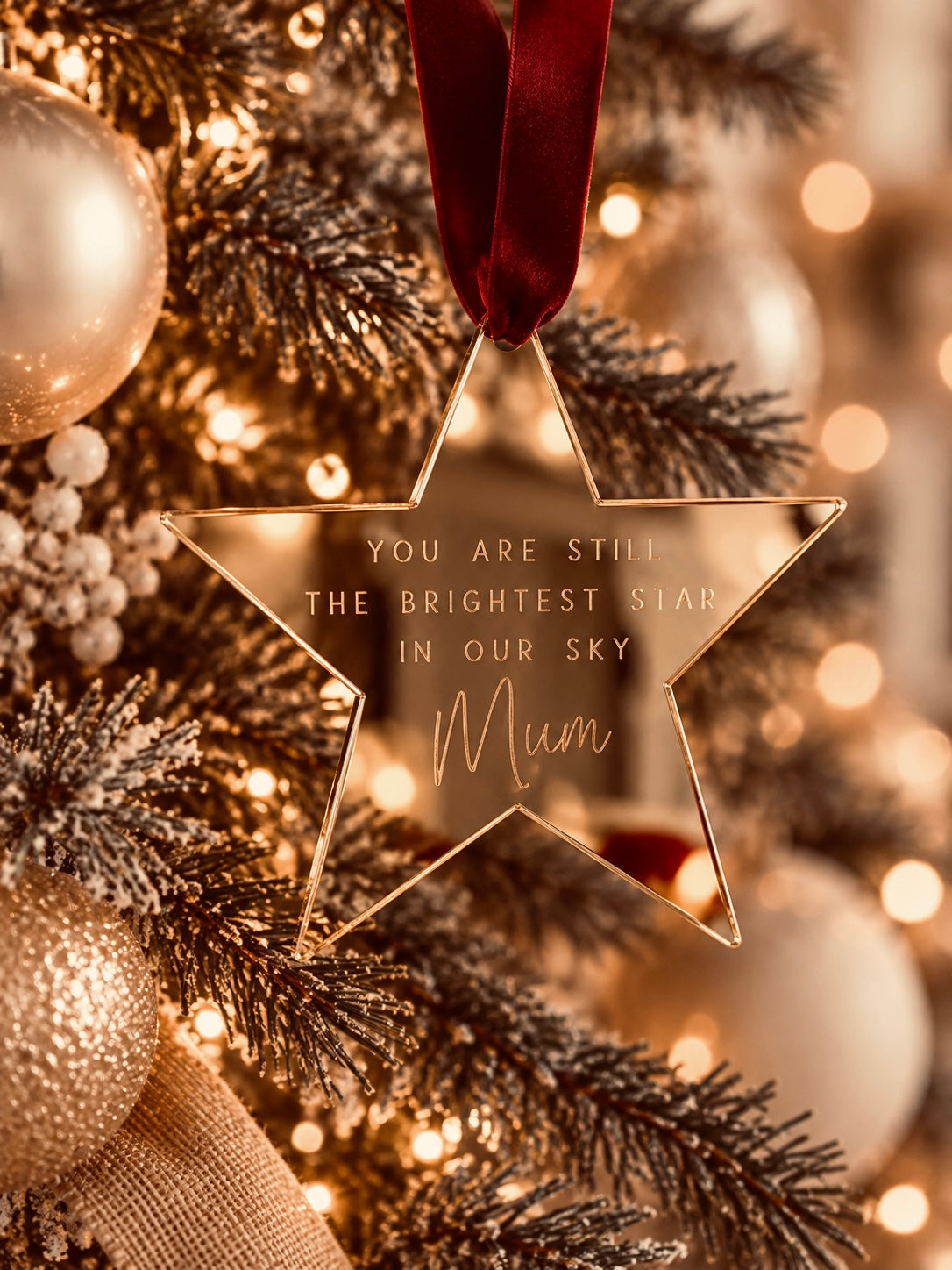Coco & May Brightest Star wooden memorial Christmas ornament hanging on a Christmas tree