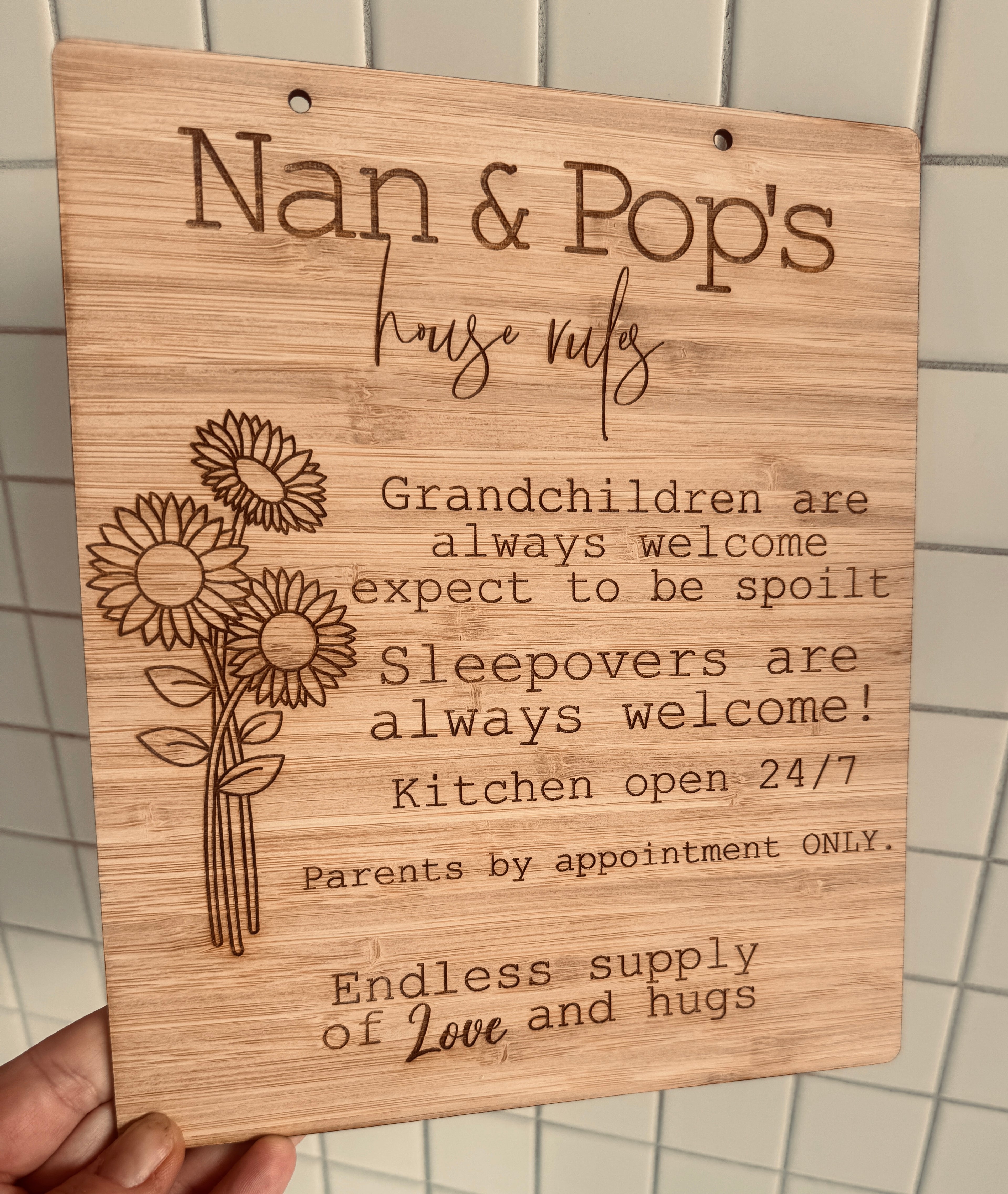 Wooden plaque engraved with 'Nan & Pop’s House Rules – Grandchildren always welcome and spoilt.