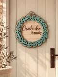 Coco & May personalised family Christmas door wreath with family name and layered leafy design