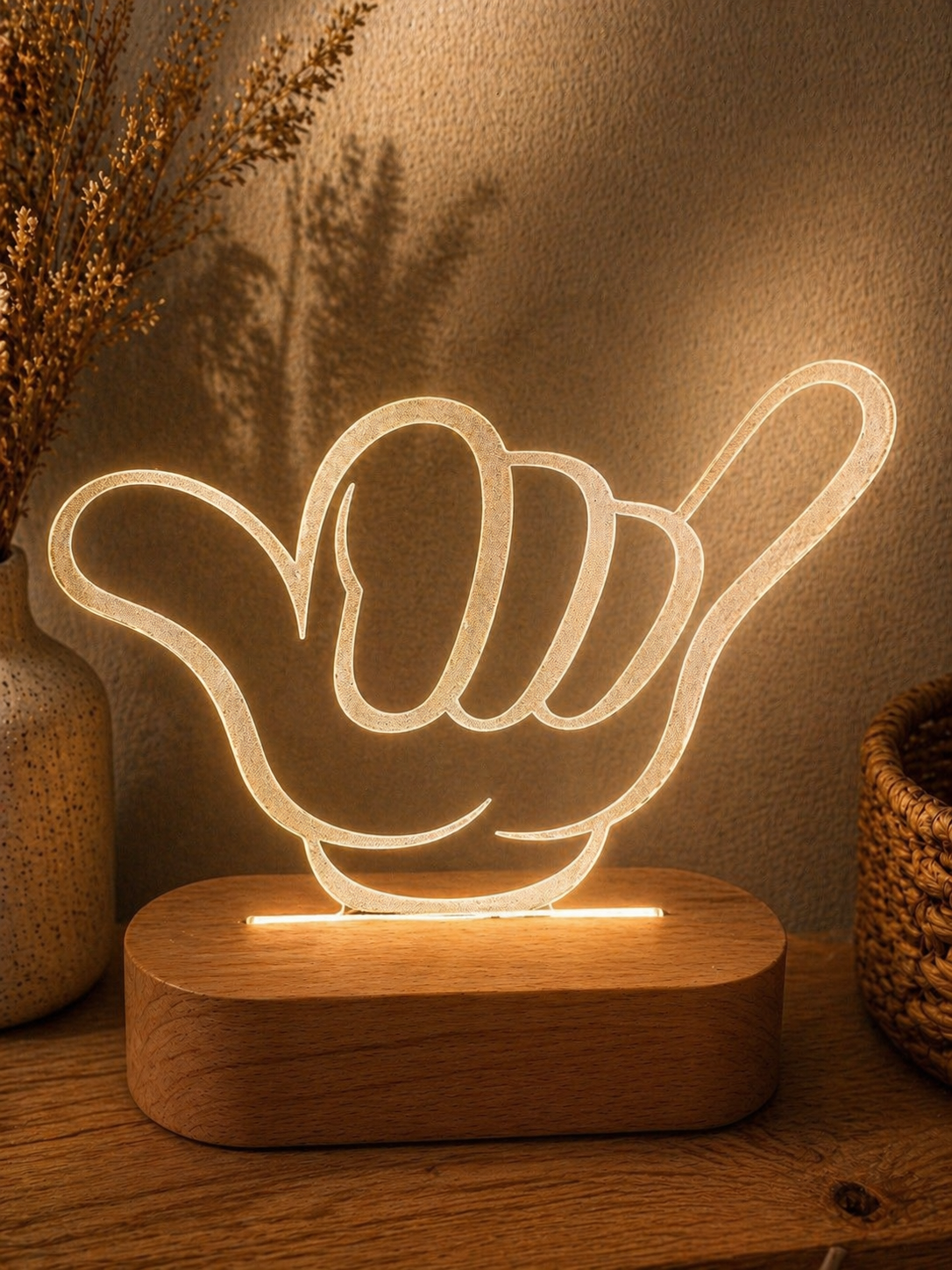 Shaka hand LED night light glowing warm on wooden base, styled for kids or teen bedroom decor
