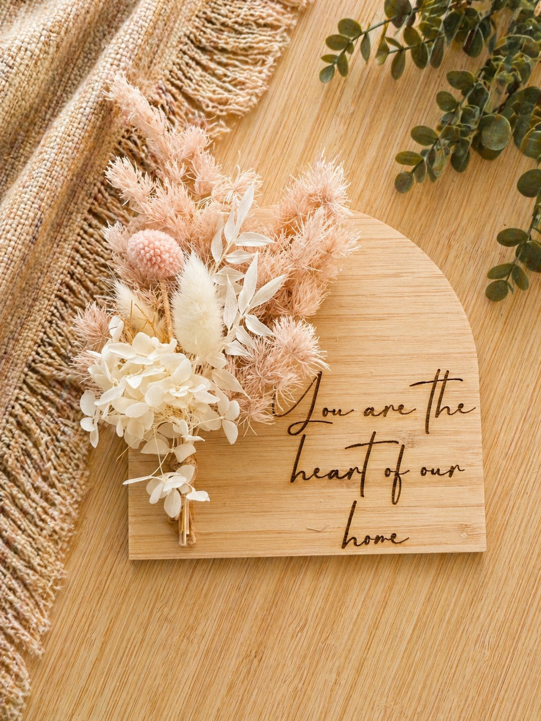Engraved wooden plaque with quote “you are the heart of our home”, styled as a meaningful gift for mum or family home
